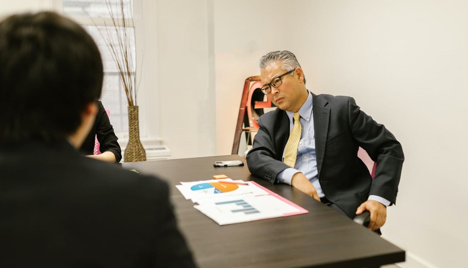 Two men at a table having a discussion in a meeting room